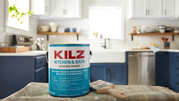 Bucket of Kilz Kitchen and bath primer sitting on countertop with freshly painted kitchen in background