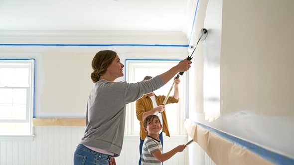 Family working together to paint a room with Kilz Primer.