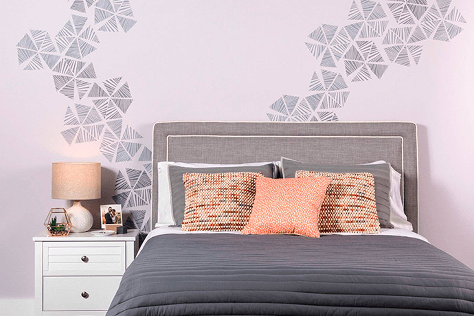 Bedroom with stenciled pattern on wall