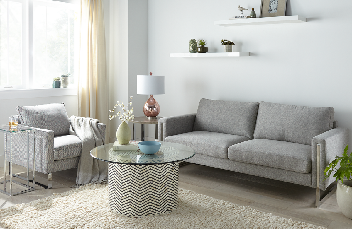 Living room with light blue walls and grey furniture