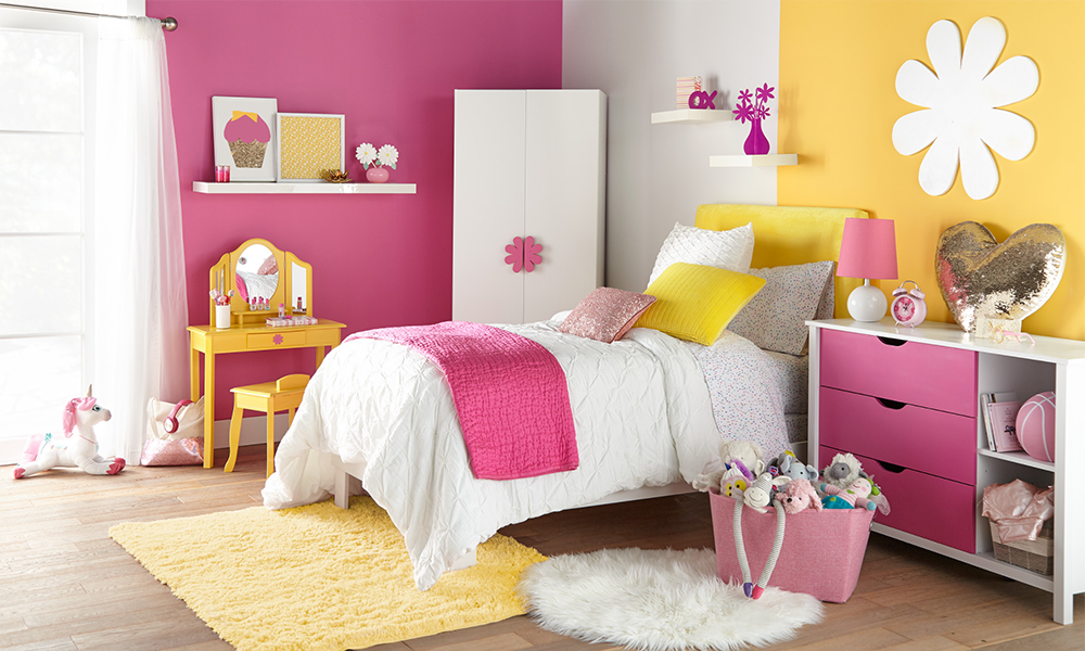 Kids bedroom that has pink, white, and yellow colored walls