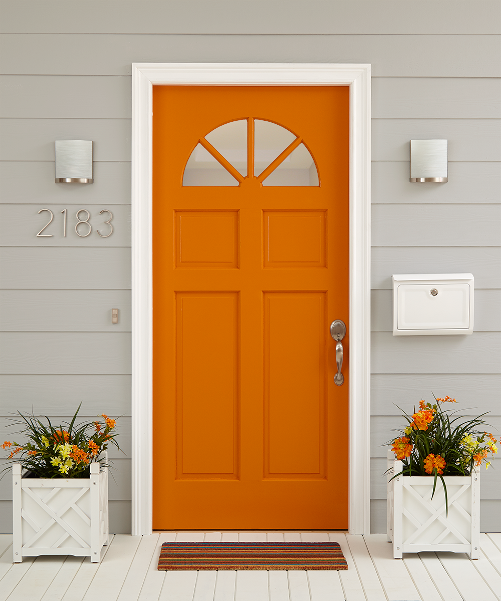 Orange exterior door with panel siding on the house