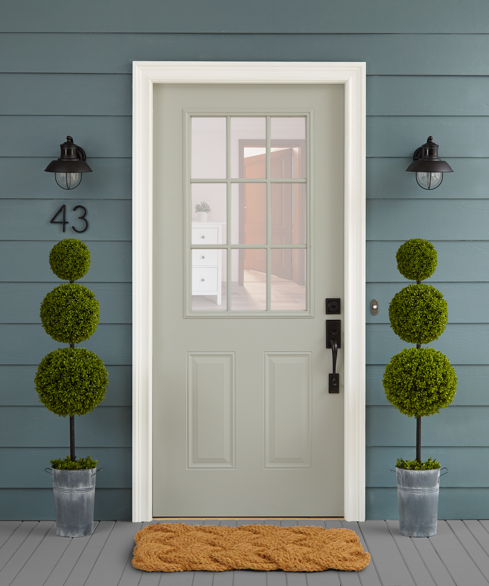 Light green exterior door with panel siding on the house