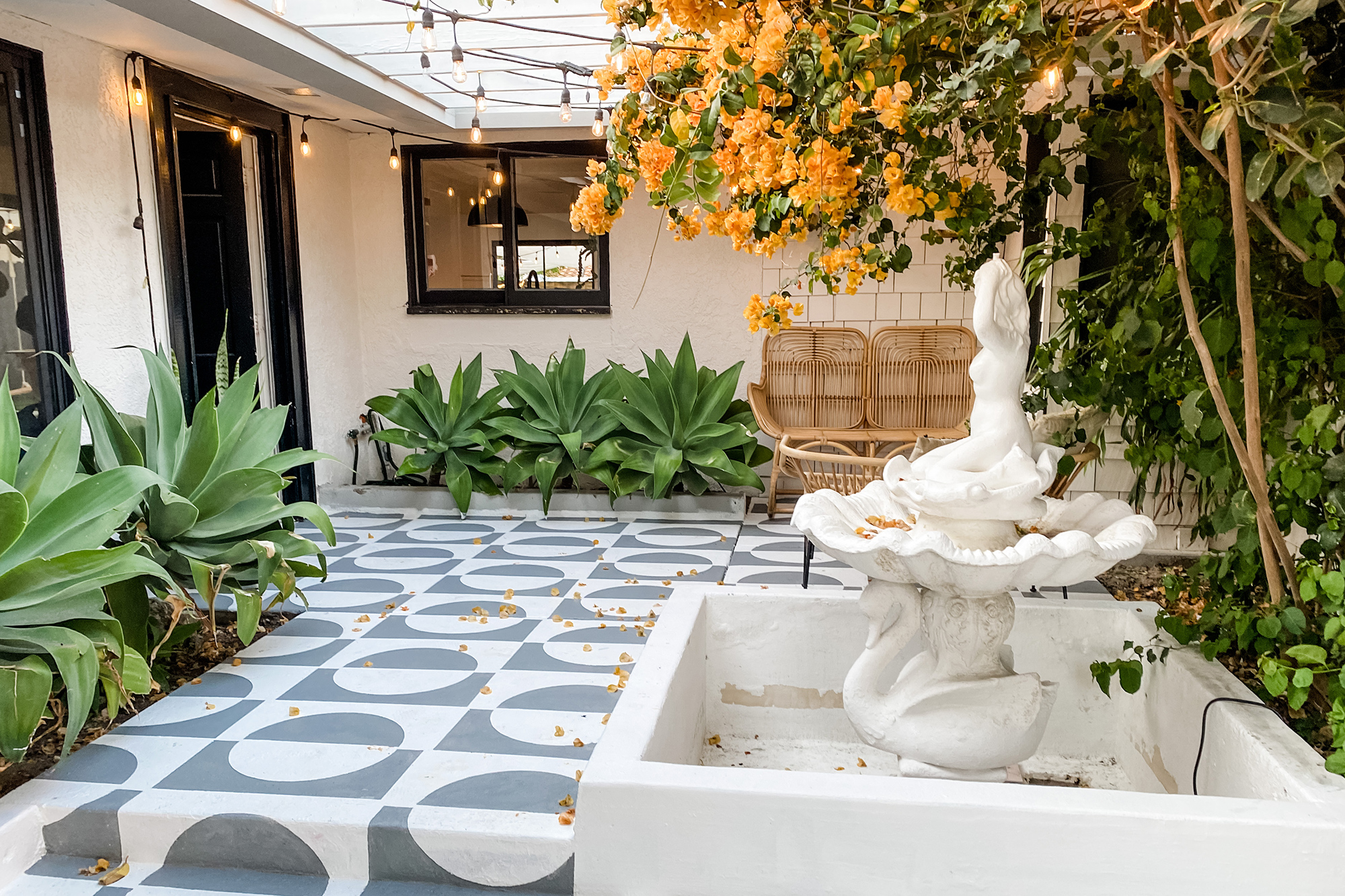 Mid century courtyard with plants and a fountain