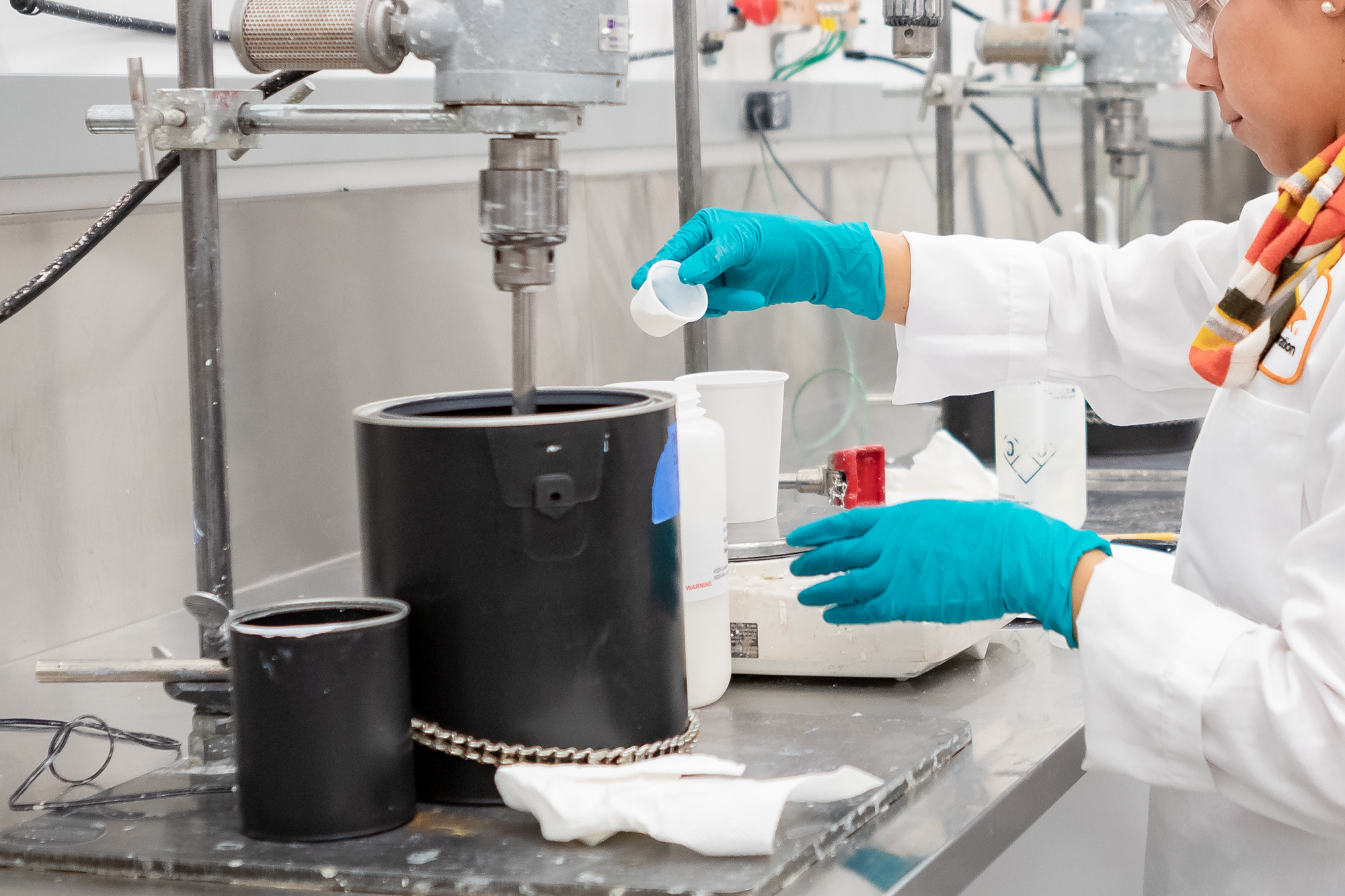 Image of a KILZ team member mixing solutions in a lab.