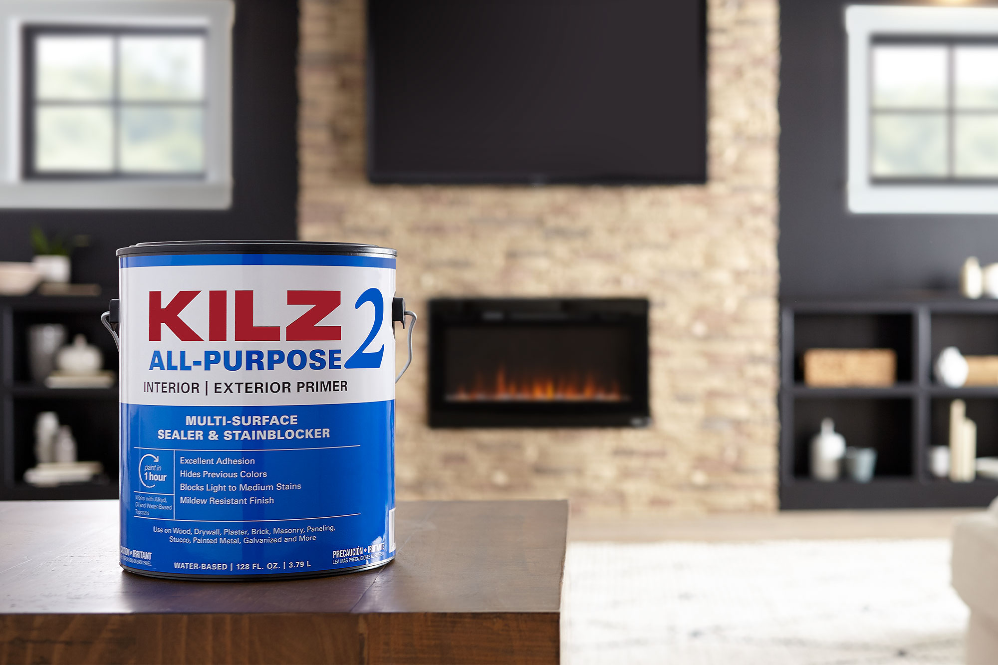 Image of KILZ 2 All Purpose Primer 1 gallon can in front of completed family room transformation