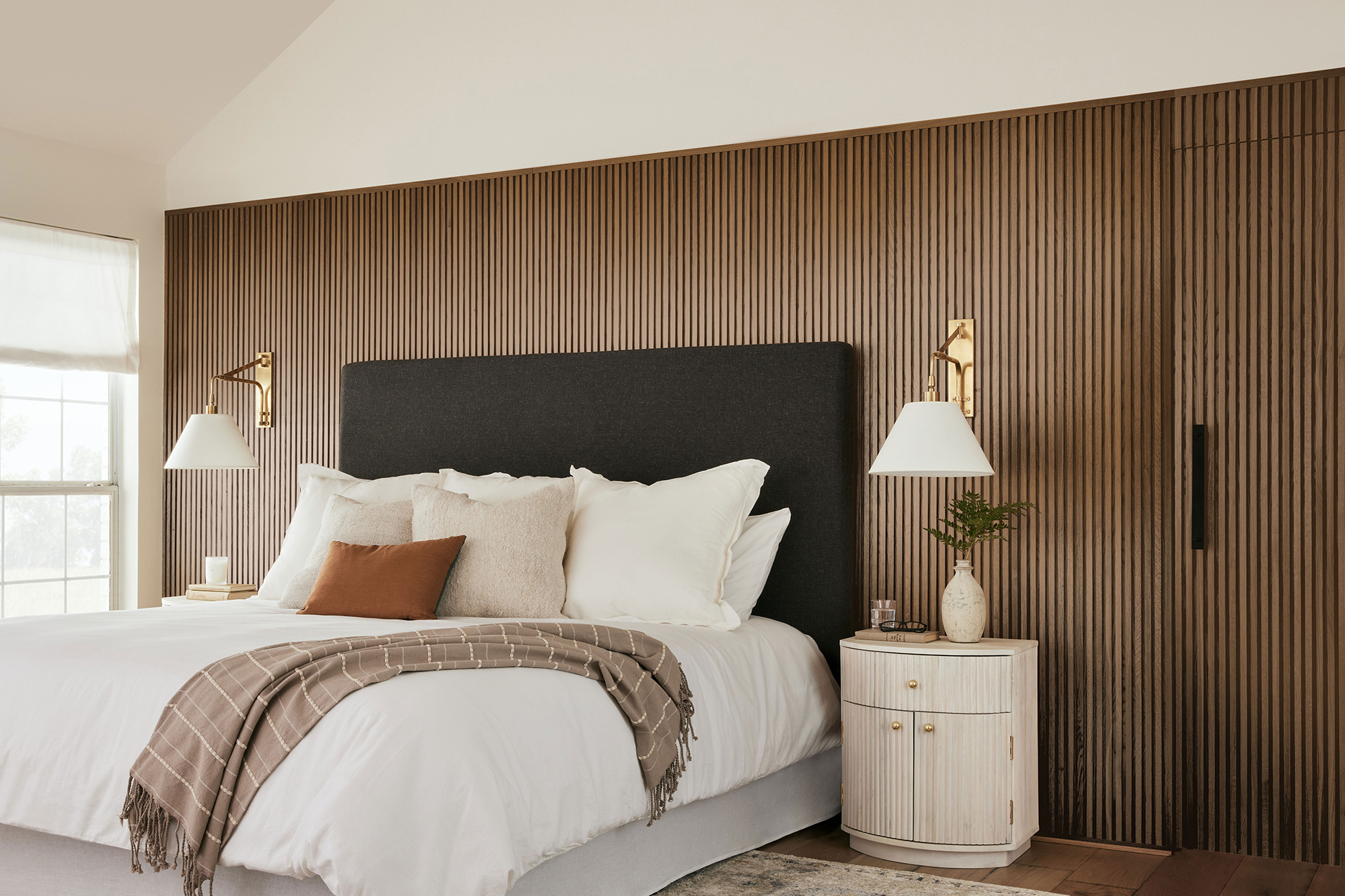 Side Image of primary bedroom with wood stained wall using Magnolia Home by Joanna Gaines® interior stain Woodsy Escape.