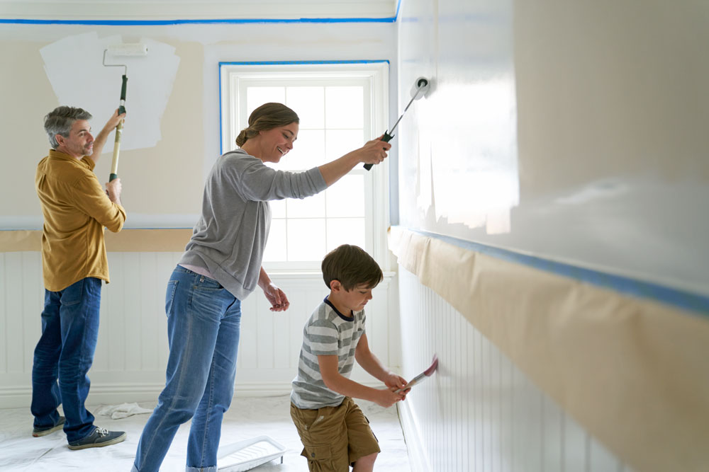 Image of a family applying primer to walls.