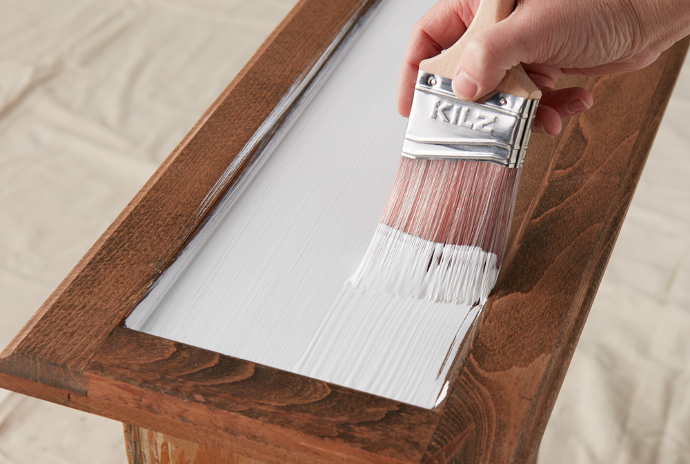 KILZ Paint Brush Covering Wood Drawer with White Primer.
