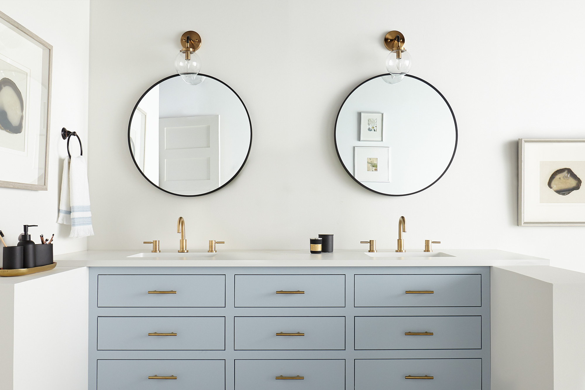 Bathroom with white walls and blue cabinets.