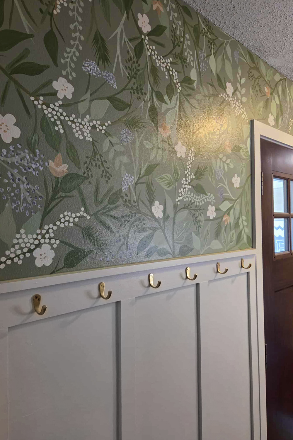 Finished wall with floral wallpaper.